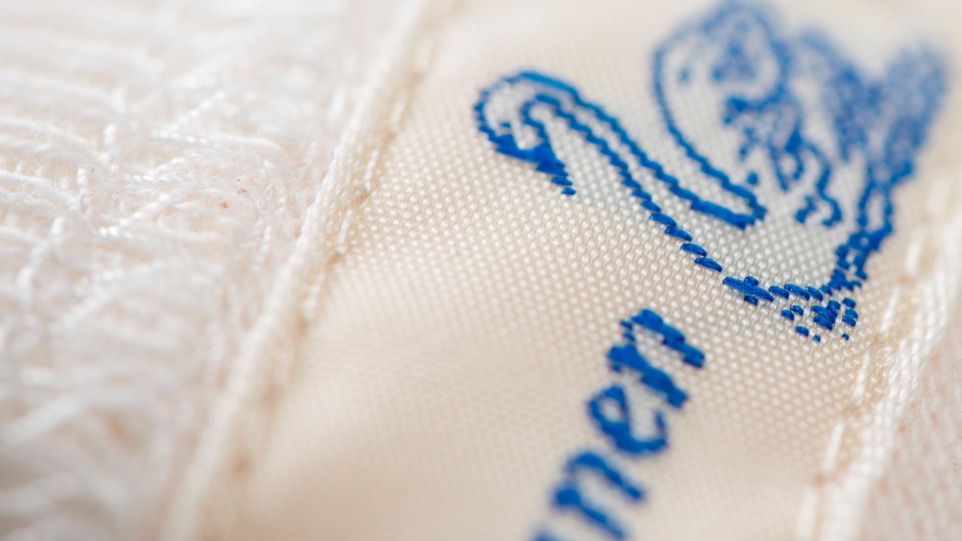 woven neck label with the blue swan