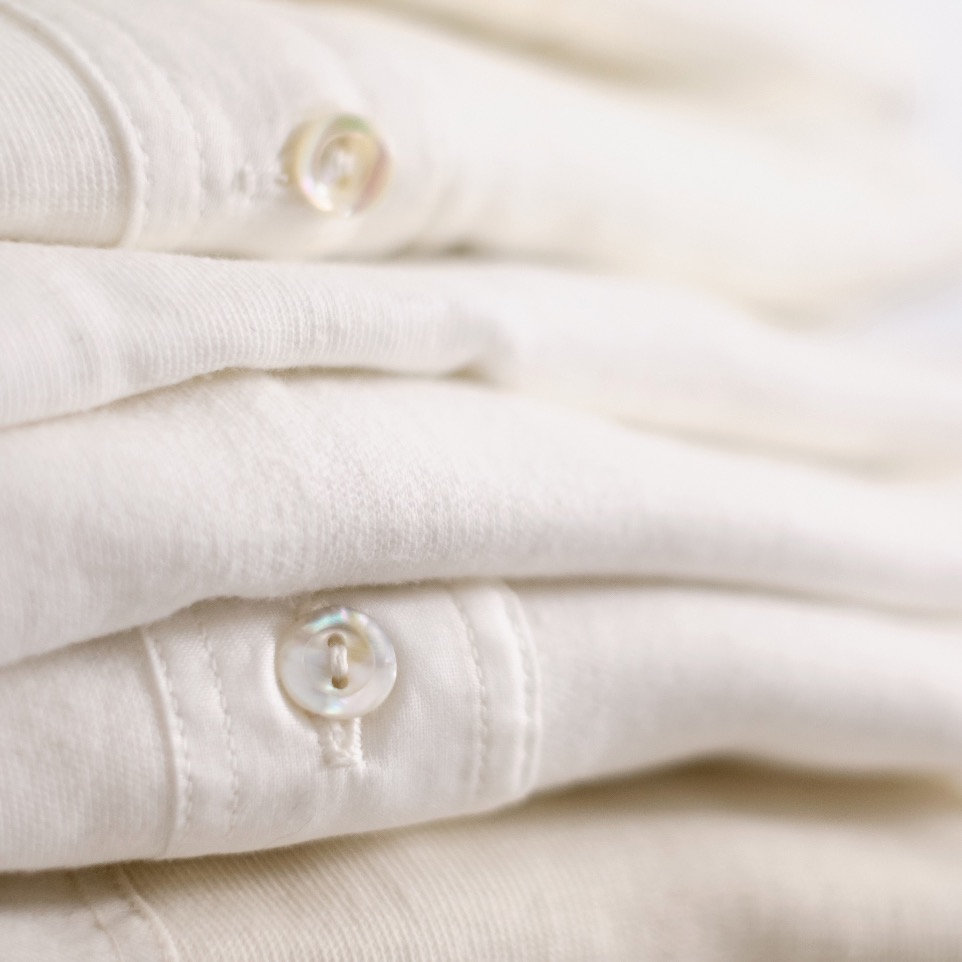 pile of organic cotton Henley's and t-shirts