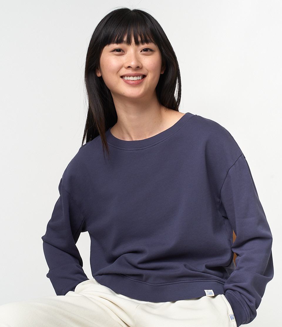 woman wearing blue organic cotton sweatshirt