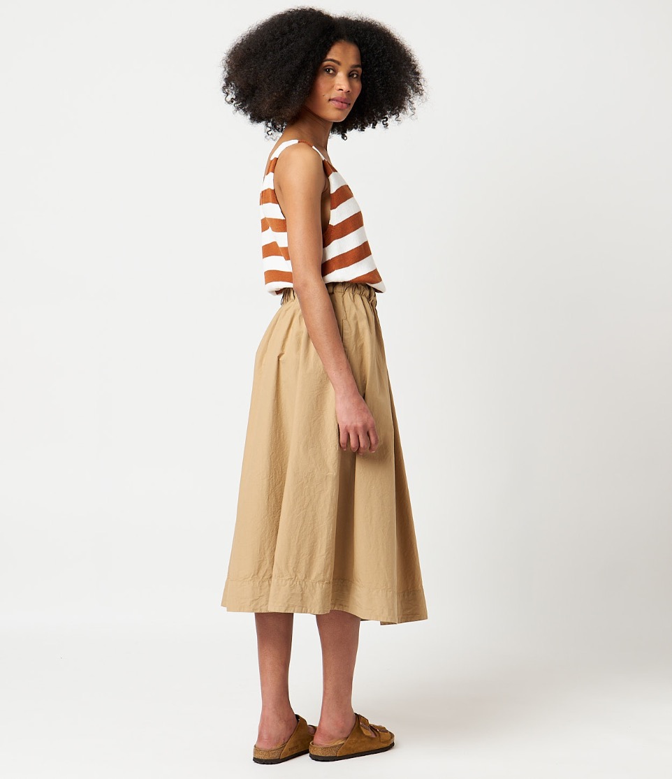 woman wearing striped top and skirt