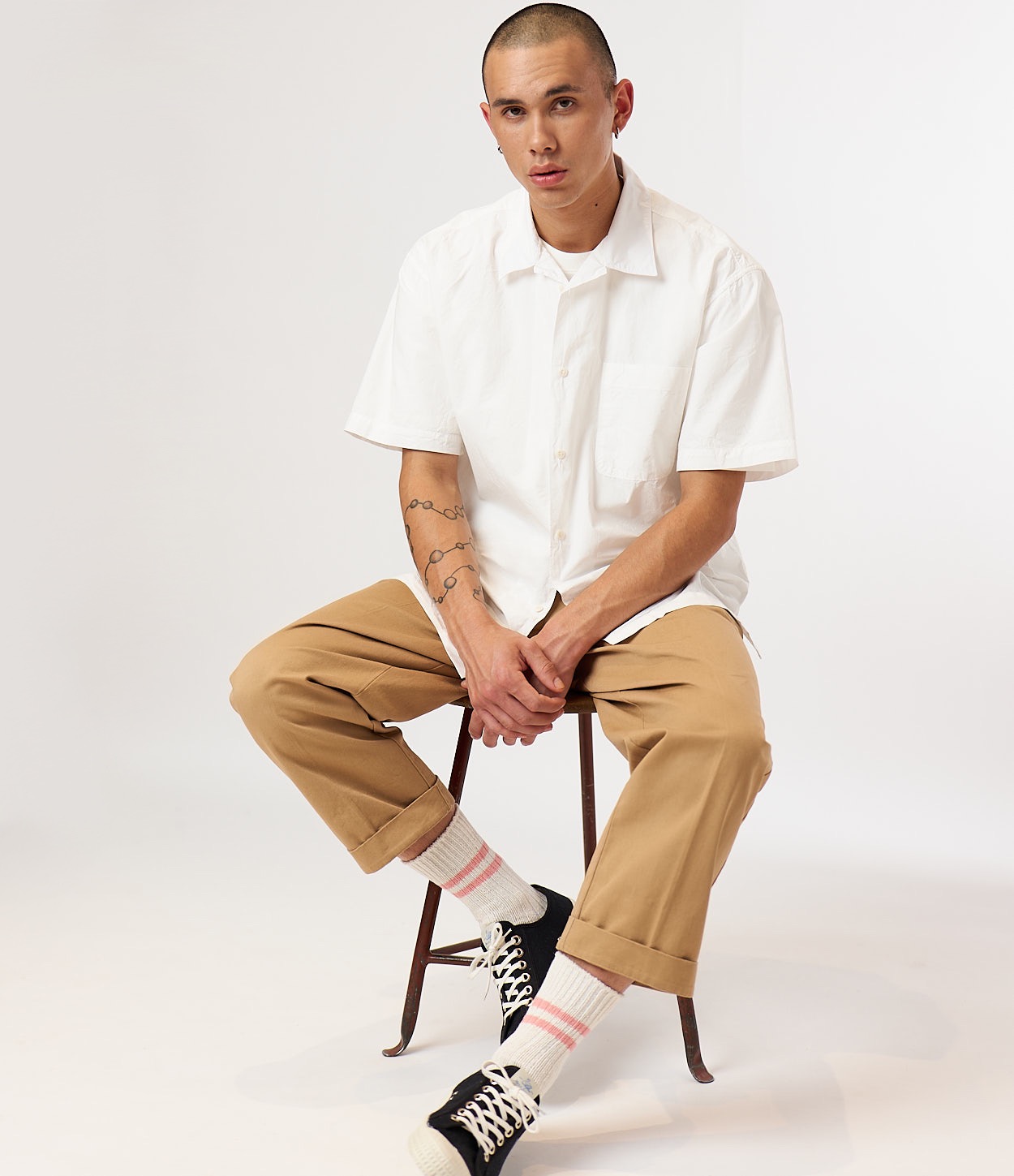 man wearing white shirt, chinos, cotton socks and novesta sneakers