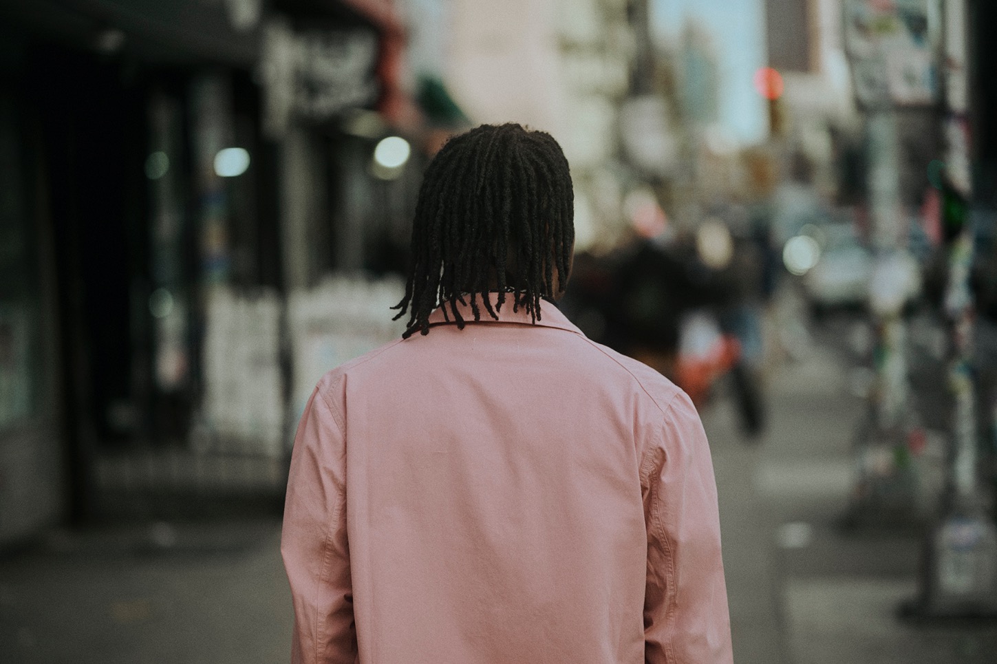 back of a man wearing a pink jacket