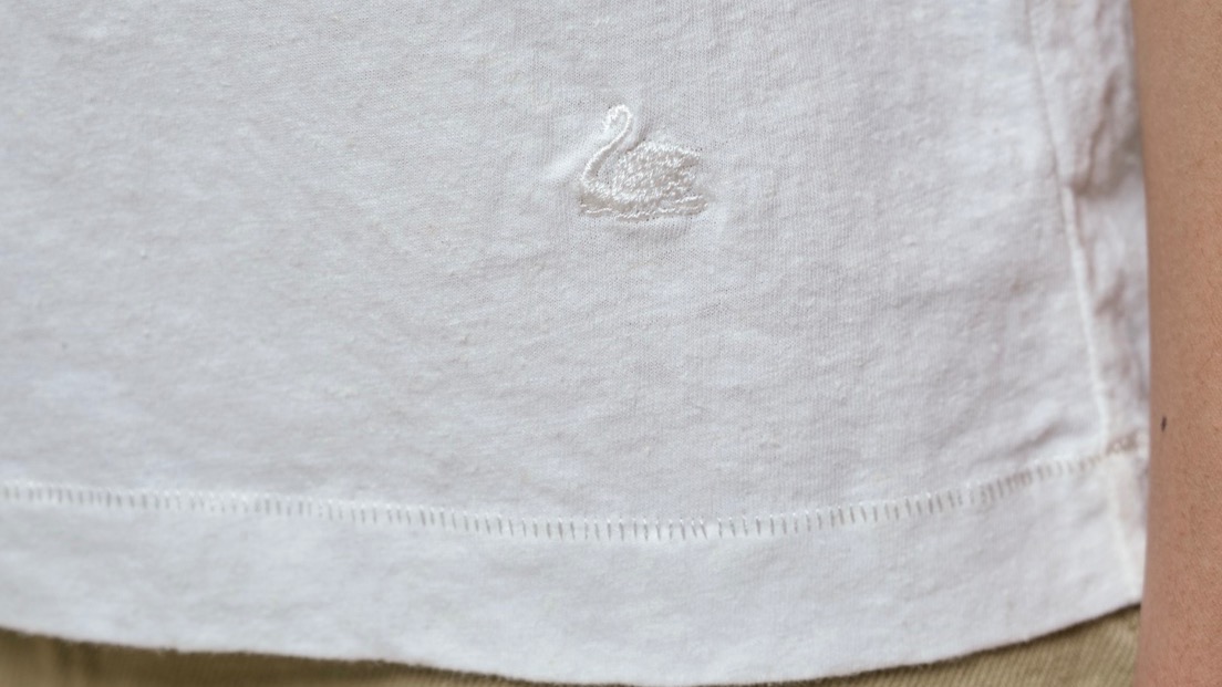 detail of swan embroidery on white t-shirt