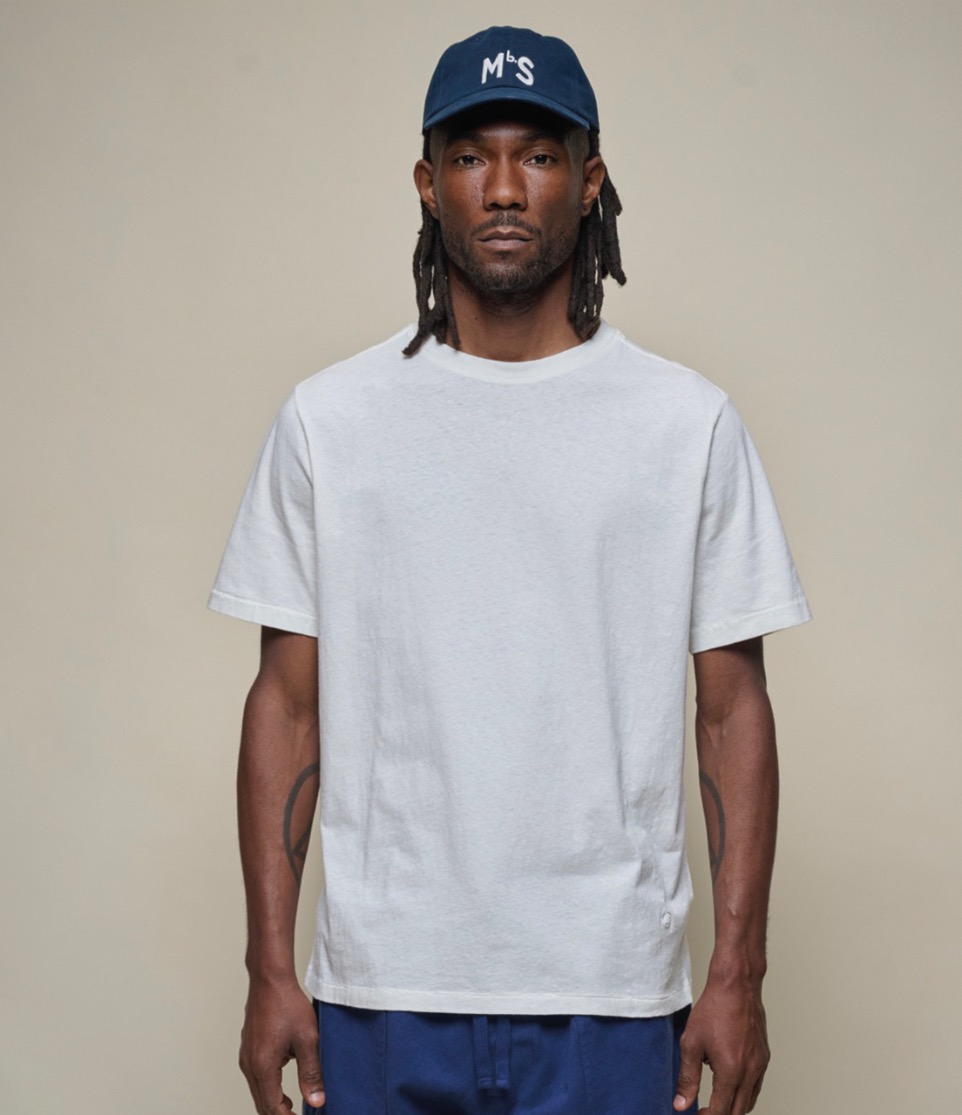 man wearing white hemp-cotton t-shirt and blue cap