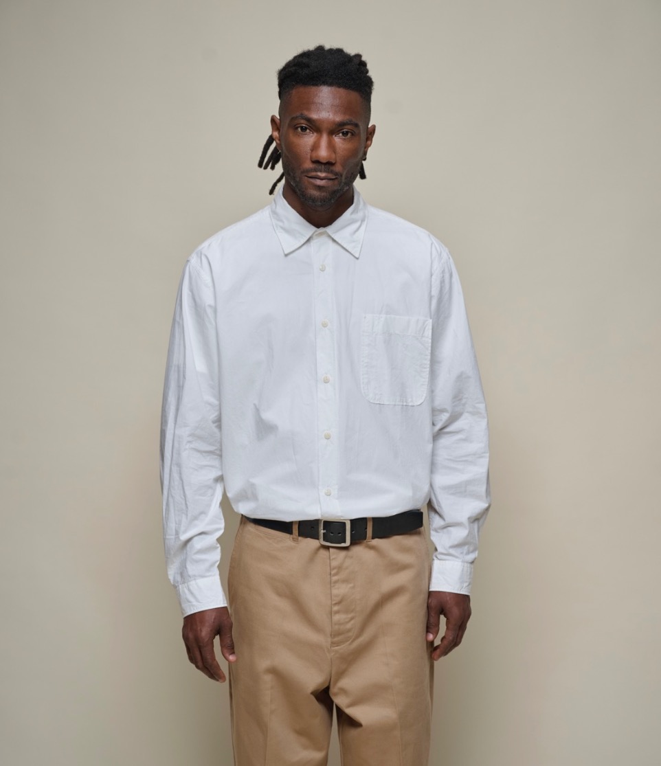 man wearing a white shirt and chinos