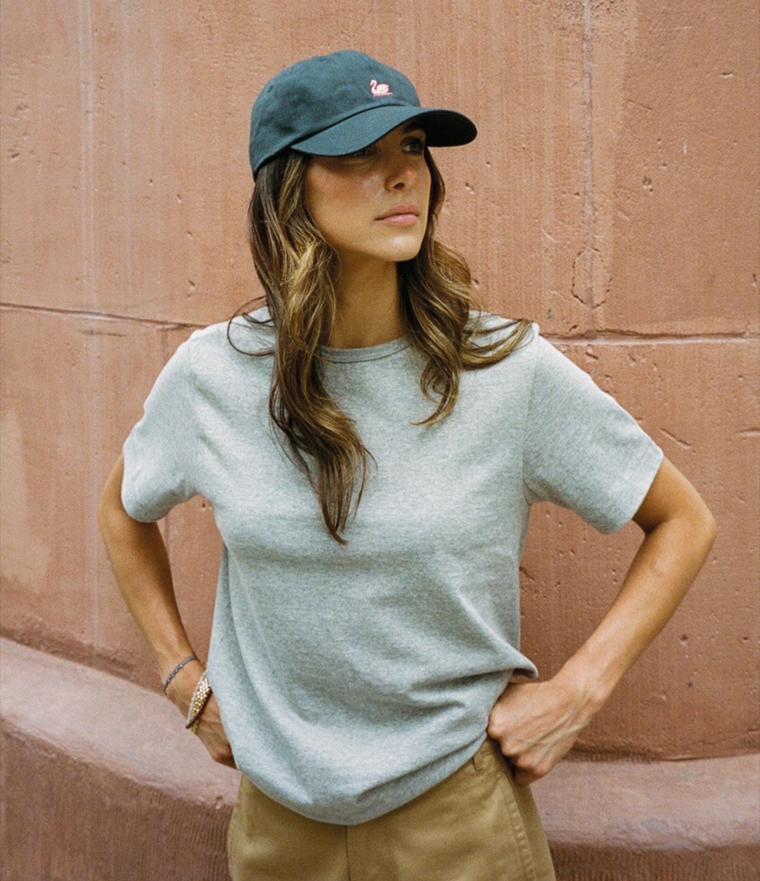 woman wearing swan logo cap and grey t-shirt