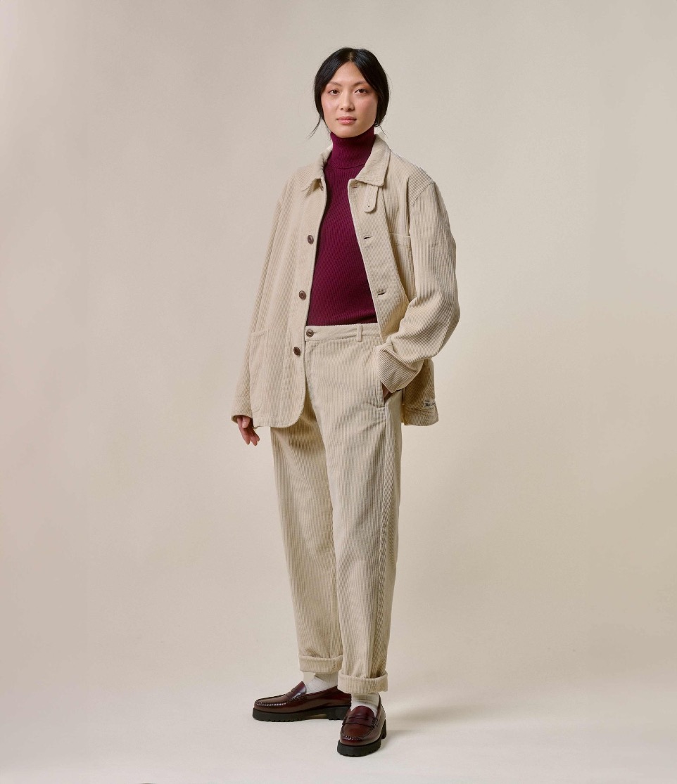 woman wearing corduroy pants and jacket and turtleneck pullover with black loafers