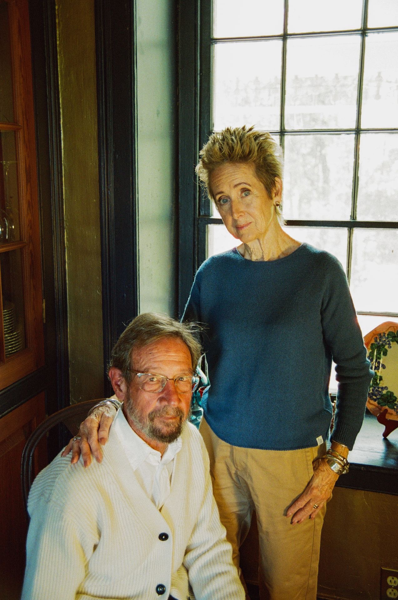 couple, the woman wears a blue pullover and the man a knitted cardigan