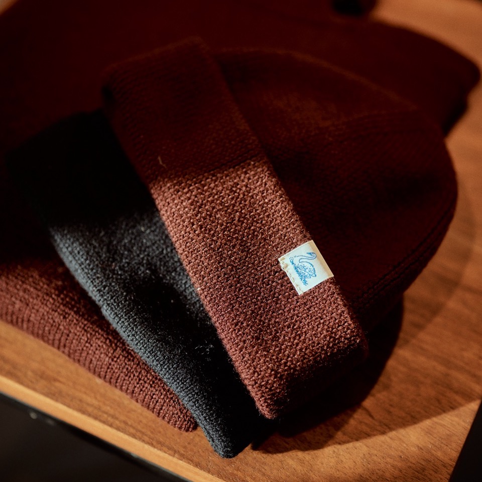 stack of merino wool beanies on a table