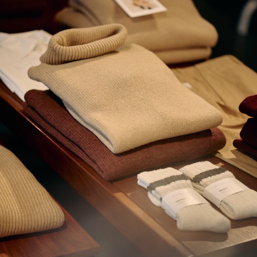 knitted pullovers and socks on the table