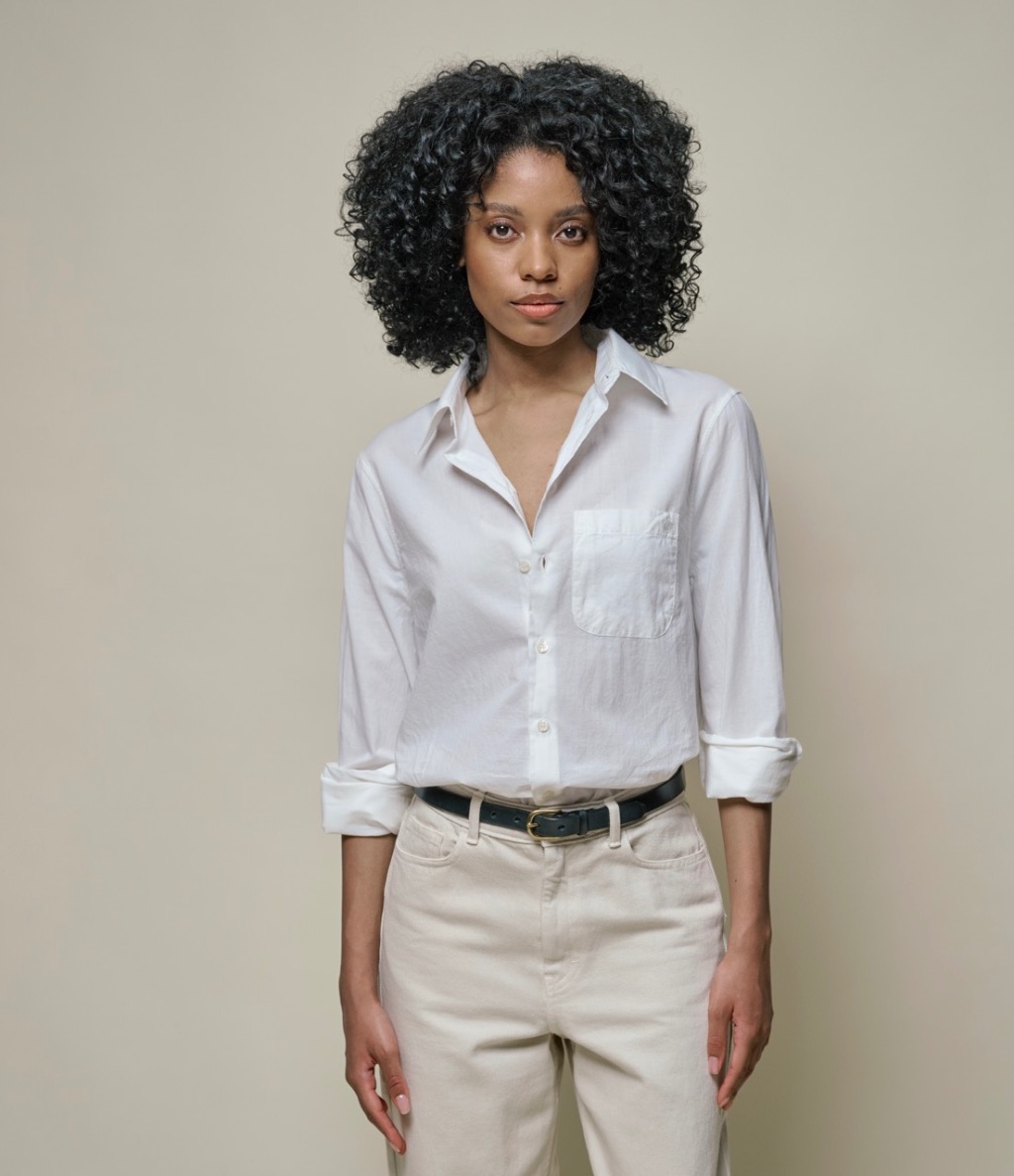 woman wearing a white blouse and pants in color nature